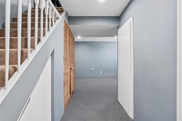 hallway with dark colored carpet