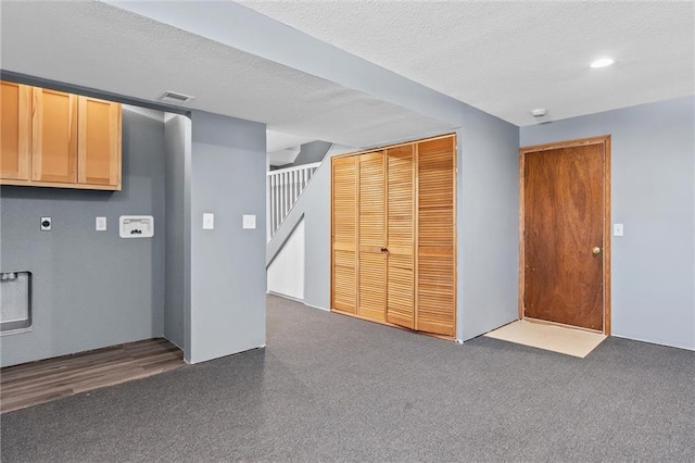 basement featuring a textured ceiling