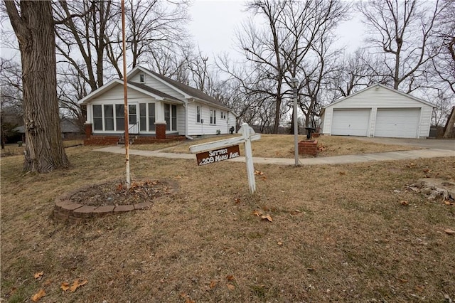 view of front of property with an outbuilding, a garage, and a front yard