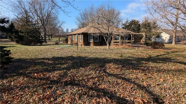 rear view of property with a yard