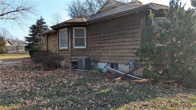 view of side of home featuring central AC