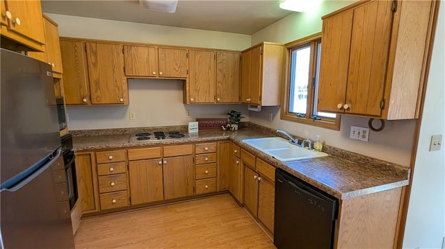 kitchen with dishwasher, light hardwood / wood-style floors, stainless steel refrigerator, white electric cooktop, and sink