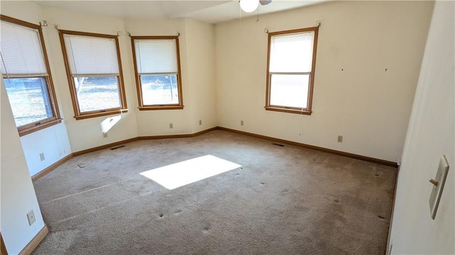 carpeted spare room with ceiling fan