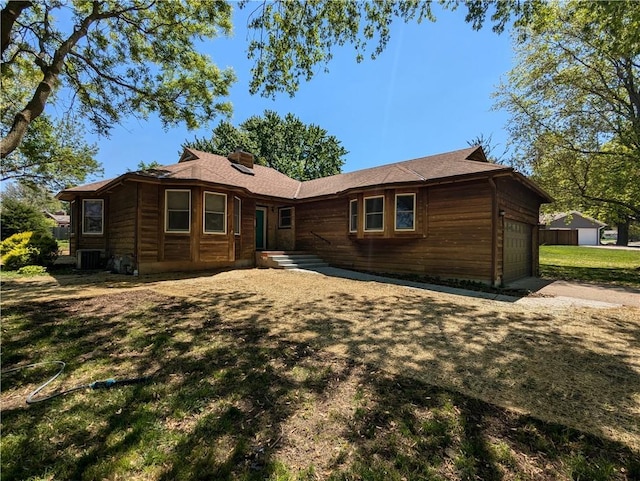 1205 Wentley Dr, Hiawatha, KS 66434 - view of front of home with driveway, cooling unit, a chimney, and a front yard