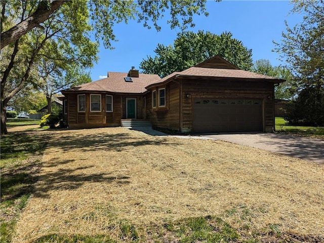 1205 Wentley Dr, Hiawatha, KS 66434 - single story home with a chimney, aphalt driveway, and a garage