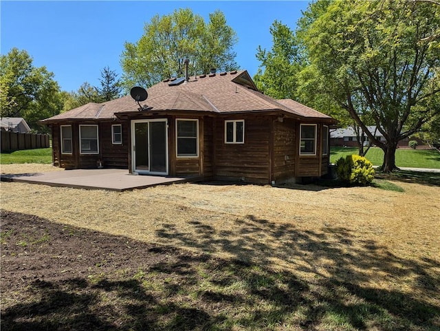 1205 Wentley Dr, Hiawatha, KS 66434 - rear view of property featuring a patio area, roof with shingles, and fence