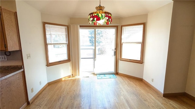 1205 Wentley Dr, Hiawatha, KS 66434 - unfurnished dining area with baseboards and light wood finished floors