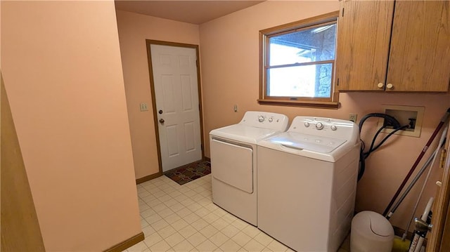 1205 Wentley Dr, Hiawatha, KS 66434 - laundry area featuring washing machine and clothes dryer, cabinet space, baseboards, and light tile patterned floors