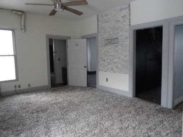 unfurnished bedroom featuring ceiling fan, a closet, and carpet