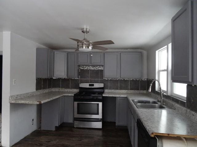 kitchen with stainless steel range with gas cooktop, gray cabinetry, and sink