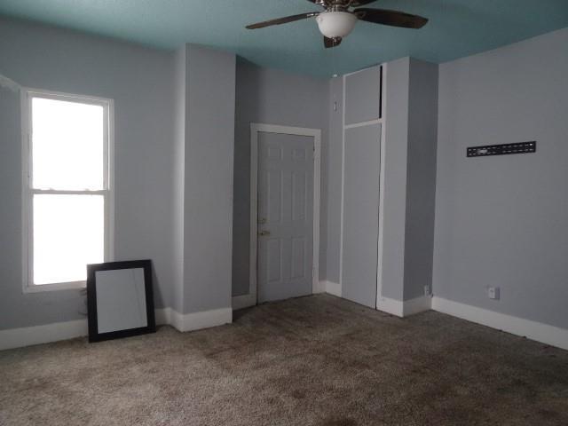 unfurnished room featuring light colored carpet, plenty of natural light, and ceiling fan