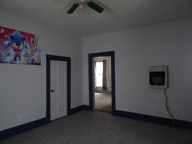 spare room with heating unit and ceiling fan