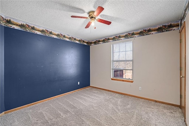 unfurnished room featuring a textured ceiling, ceiling fan, and carpet flooring