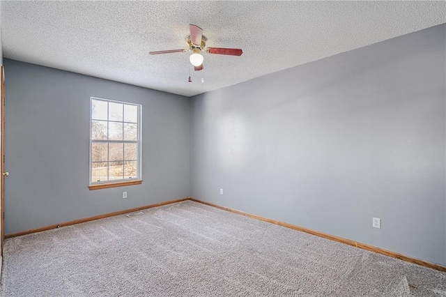 carpeted empty room with a textured ceiling and ceiling fan