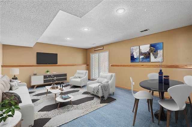 living room featuring a textured ceiling and carpet flooring