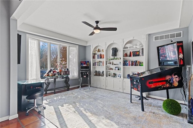 interior space featuring built in shelves and ceiling fan