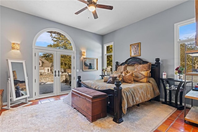 tiled bedroom with french doors, access to outside, and ceiling fan