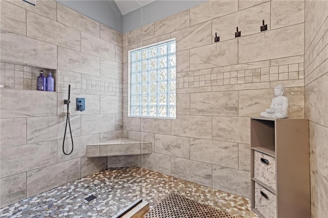 bathroom with a tile shower