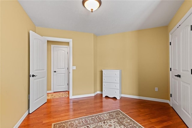 unfurnished bedroom with wood-type flooring