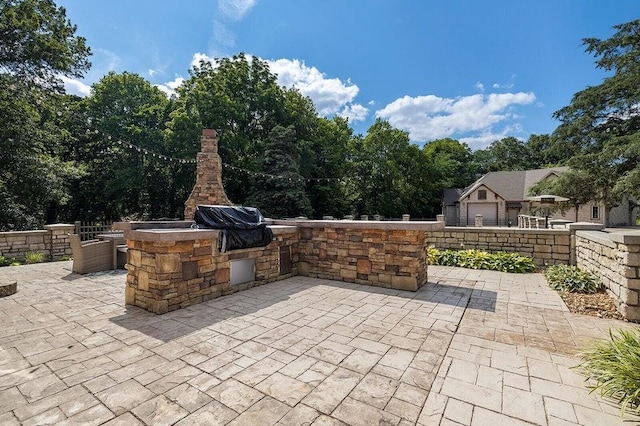 view of patio with an outdoor kitchen and area for grilling