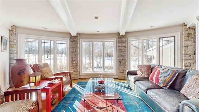 living room with beamed ceiling and wood-type flooring