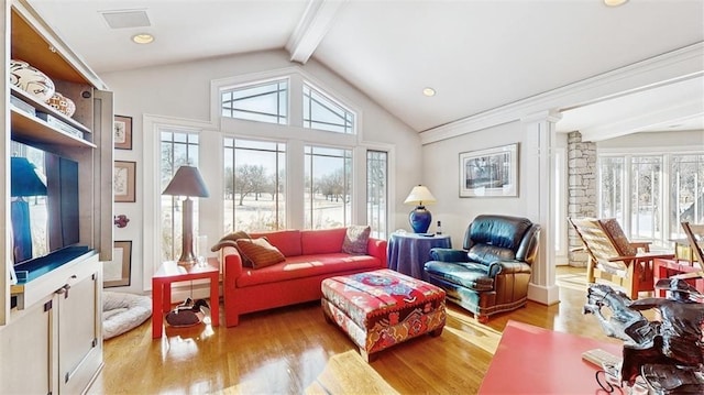 living room featuring ornate columns, lofted ceiling with beams, and light hardwood / wood-style flooring