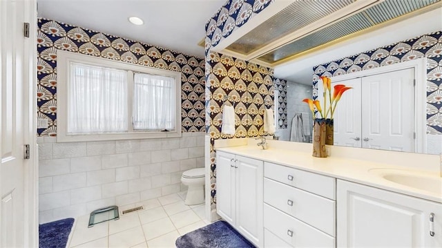 bathroom featuring toilet, vanity, and tile patterned floors