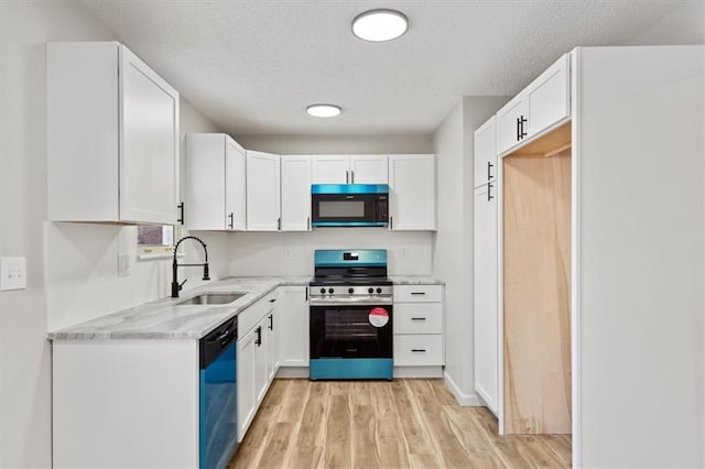 kitchen with white cabinetry, dishwasher, and electric stove