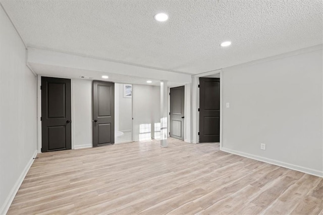 interior space with a textured ceiling and light wood-type flooring