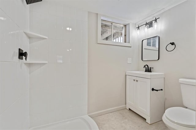 bathroom featuring toilet, vanity, and walk in shower