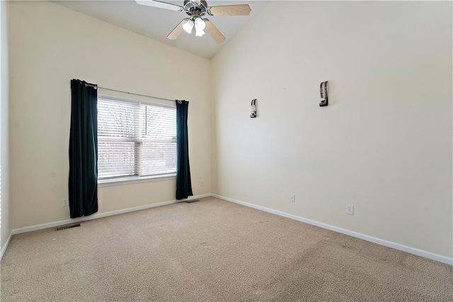 carpeted empty room with vaulted ceiling and ceiling fan