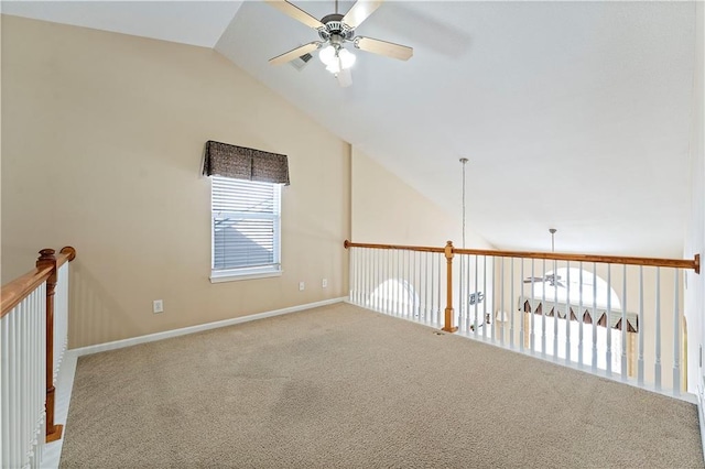 carpeted spare room featuring ceiling fan and lofted ceiling