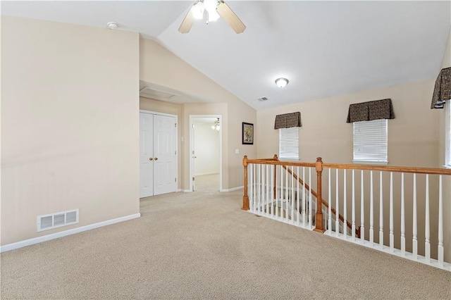 unfurnished room with light colored carpet, ceiling fan, and lofted ceiling