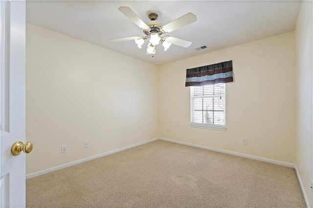 carpeted empty room featuring ceiling fan