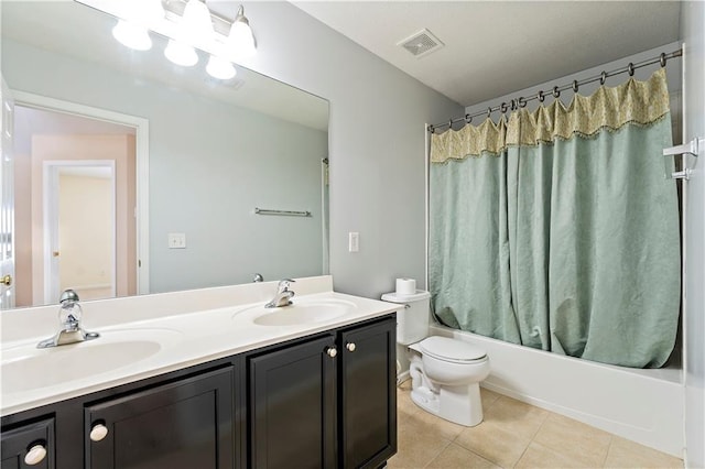 full bathroom featuring shower / bath combo with shower curtain, tile patterned flooring, vanity, and toilet