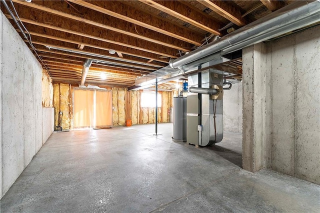 basement featuring gas water heater and heating unit