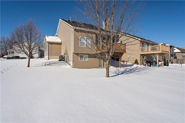 snow covered house with a deck