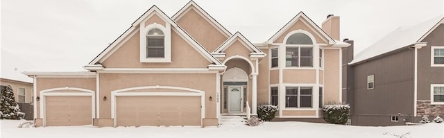 view of front of home with a garage and stucco siding