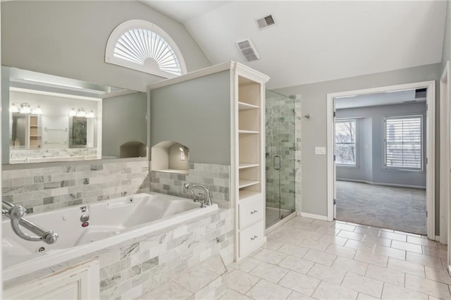 bathroom with lofted ceiling, a stall shower, a tub with jets, and visible vents