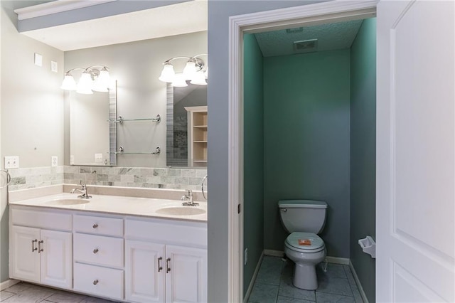 full bathroom featuring tasteful backsplash, visible vents, a sink, and toilet