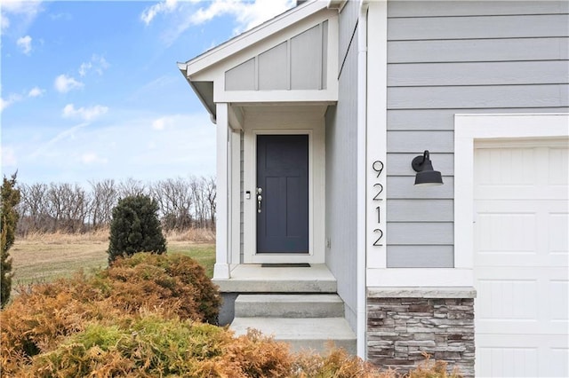 doorway to property with a garage