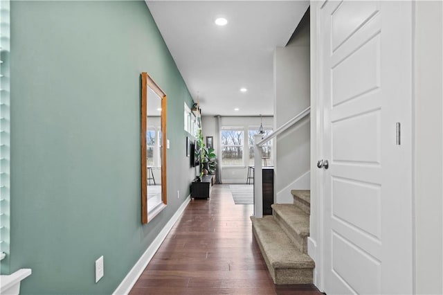 corridor featuring stairs, dark wood-style flooring, recessed lighting, and baseboards