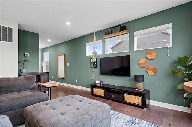 living area with visible vents, baseboards, wood finished floors, and recessed lighting