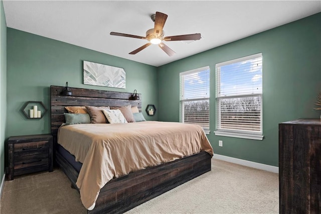 bedroom with baseboards, a ceiling fan, and light colored carpet