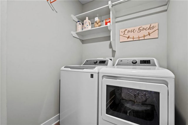 laundry area featuring laundry area, baseboards, and separate washer and dryer