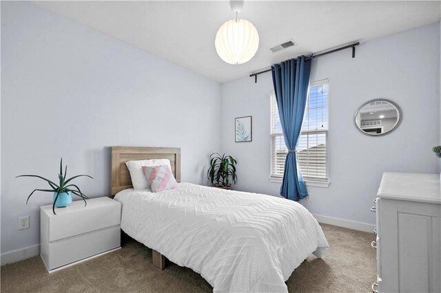 bedroom with baseboards, visible vents, and light colored carpet