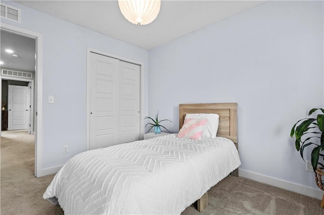 bedroom with light carpet, baseboards, visible vents, and a closet