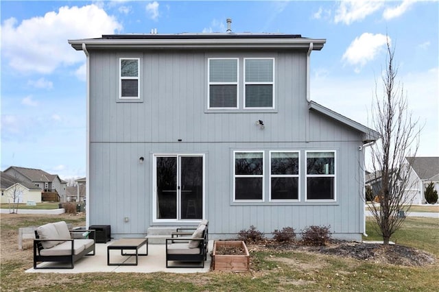 rear view of property featuring an outdoor hangout area, a yard, a patio area, and entry steps