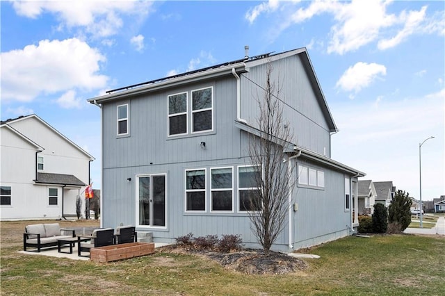 back of property featuring outdoor lounge area, a lawn, and a patio