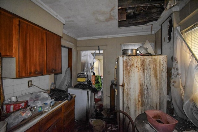 kitchen featuring washer / clothes dryer and tasteful backsplash